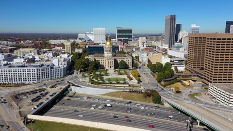 ATLANTA, GEORGIA - CIRCA 2020s - Good aerial of the Atlanta State Capitol building in Atlanta, Georgia with skyline background.
