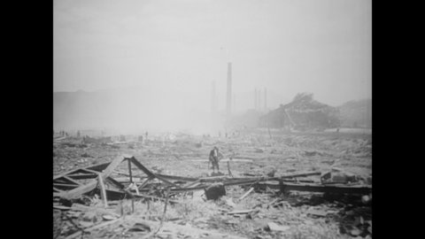 CIRCA 1945 - Villagers walk among the wreckage of wooden structures demolished by the atomic bomb in Nagasaki.