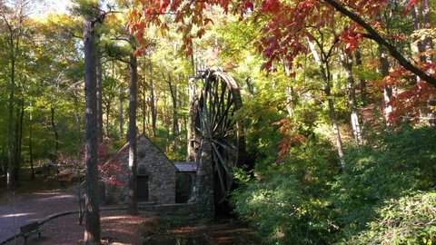 ROME, GEORGIA - CIRCA 2020s - Beautiful aerial of waterwheel at an old mill in the forest in Rome, Georgia.