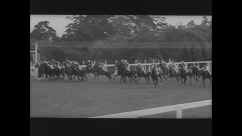 CIRCA 1964 - Queen Elizabeth II watches a horse race at the Royal Ascot racetrack.