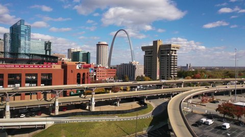 ST. LOUIS MISSOURI - CIRCA 2020s - Good aerial over freeway past Busch Stadium reveals the Gateway Arch of St. Louis, Missouri.