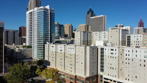 ATLANTA, GEORGIA - CIRCA 2020s - Rising aerial of apartment complex and high rises in downtown Atlanta, Georgia business district.