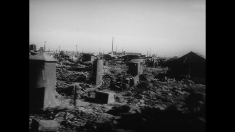 CIRCA 1945 - Drive through an intersection of a war-torn Japanese city.