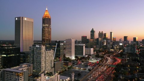 ATLANTA, GEORGIA - CIRCA 2020s - High establishing aerial shot of Atlanta, Georgia downtown skyline at dusk, sunset or night.