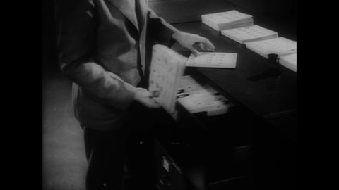 CIRCA 1936 - Fingerprint records are checked at the FBI.
