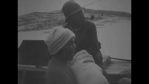 CIRCA 1925 - Scientific explorers meet Inuit families in Greenland.