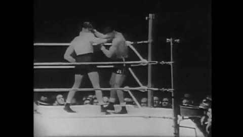 CIRCA 1935 - Joe Louis and Max Baer begin a boxing match.