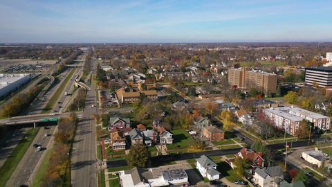 EAST LANSING, MICHIGAN - CIRCA 2020s - Good aerial over East Lansing, Michigan, suburbs, freeway, highway.