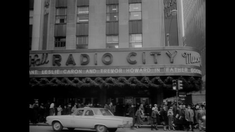 CIRCA 1965 - A couple who buys the record-setting ticket to "Father Goose" at New York City's Radio City Music Hall is given media attention.
