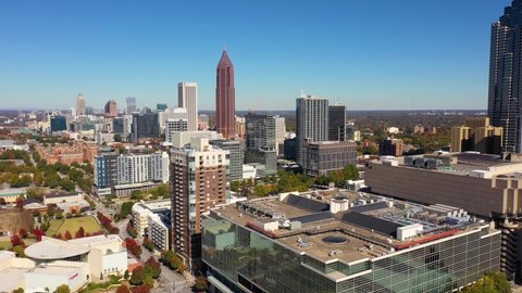 ATLANTA, GEORGIA - CIRCA 2020s - Excellent aerial of Atlanta, Georgia city skyline ends on a pool at the top of a luxury high rise apartment complex.