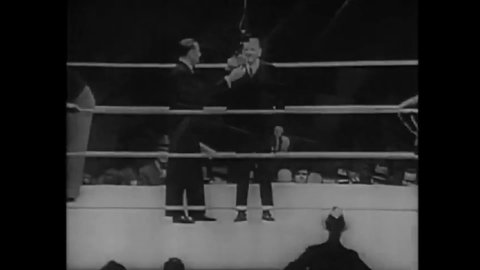 CIRCA 1935 - The announcer introduces Max Baer and Joe Louis at a boxing match.