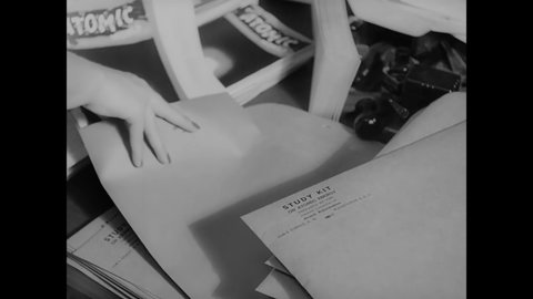 CIRCA 1946 - Volunteers stuff envelopes with information about atomic research by the Federation of American Scientists.