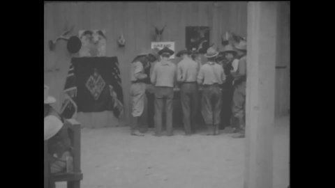 CIRCA 1914 - In this western film, men play craps and other games at a saloon.