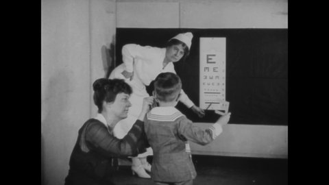 CIRCA 1919 - A young boy gets his vision and hearing tested.
