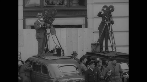 CIRCA 1937 - Cameramen and CBS radio men record an American Legion parade in New York City.