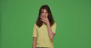 Bad smell. Beautiful young girl pinch nose, frowning in displeasure from disgusting stink on chromakey green background