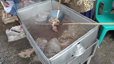 The process of boiling beef broth in a large pot