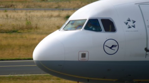 FRANKFURT AM MAIN, GERMANY - JULY 17, 2017: Passenger Airbus 320 Lufthansa taxiing the taxiway at Frankfurt Airport, Germany (FRA). Cockpit close-up, side view