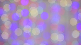 Christmas beautiful multicolored lights burn brightly out of focus. New Year's light on a pink background. Video, footage for screensaver, intro, presentation, transition, congratulations, effects.4K.