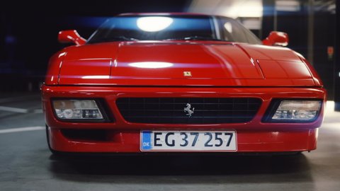 AARHUS, DENMARK - OCTOBER 2021: Medium Dolly Shot Moving Over The Hood And Away From A Red Ferrari 348 TB