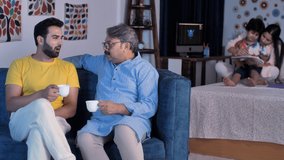 A well-groomed young man and his elderly father drinking tea coffee together. Father and son bonding, Serious discussion between father and son. Caring mother with her son - family bonding, happy... - Powered by Shutterstock - Get 15% off with code: PIKWIZARD15