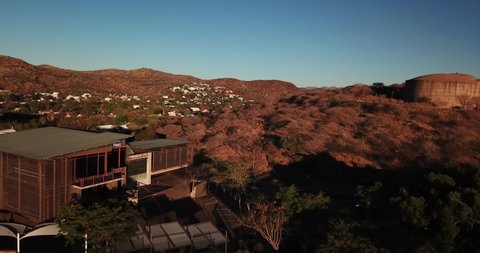 Windhoek, Khomas Region, central Namibia, 09.01.20: 4K aerial Windhoek capital residential central hilly district bright sunset drone video, upmarket houses, old white walls German mansion on hill top