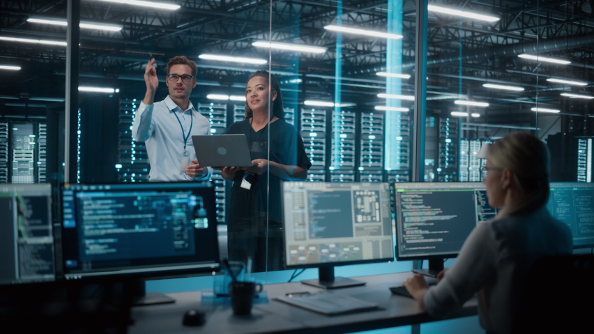 Big Data Center Server Room: Female e-Business Enrepreneur and Male IT Specialist talk, Use Laptop. Information Technology Engineer and System Administrator work on Web Services Cloud Computing SAAS - Powered by Shutterstock - Get 15% off with code: PIKWIZARD15