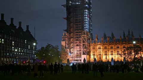 LONDON - NOVEMBER 5, 2021: Protesters at Million Mask March in Parliament Square. Houses of Parliament in the background.