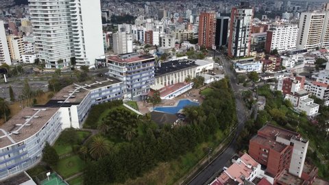 beautiful city in Latin America with buildings, paved street, a pool and trees, nature and modern infrastructure, aerial view of the landscape of Quito Ecuador in the day, scene of tranquility