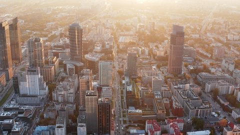 Aerial panoramic footage of high rise downtown buildings. Shot against morning glowing sun. Warsaw, Poland