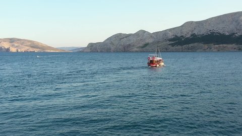Boat Sailing On Adriatic Coast Towards The Krk Island In Croatia. aerial