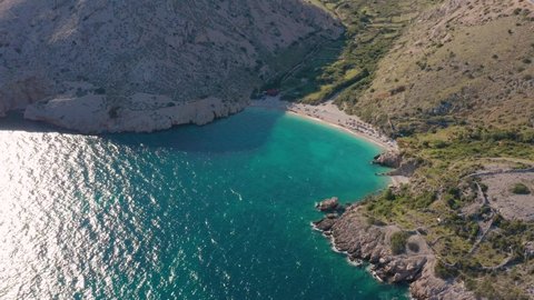 Small Beach Surrounded With Rocky Clifffs At The Shore Of Adriatic Coast In Krk, Croatia. aerial