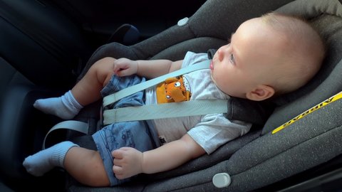 Baby boy is riding in the Infant Car Seat (Group 0, or infant carrier) in a rear-facing position.