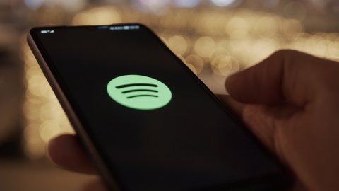 Sofia, Bulgaria, November 2021 - Music listening on smartphone via streaming platform Spotify application
