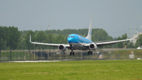 AMSTERDAM, THE NETHERLANDS - JULY 27, 2017: Boeing 737 of KLM landing at Shiphol Airport, Amsterdam (AMS). Tourism and travel concept. KLM planes at the airport, traffic