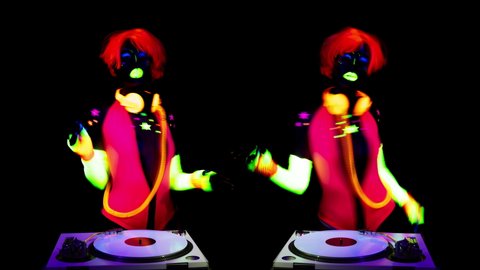 A cool sexy djing woman wearing UV fluorescent clothing and makeup and mirrored