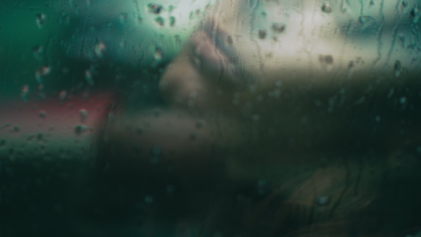 solitude, sadness - depressive woman behind the glass wet with rain Royalty-Free Stock Footage #1083732115
