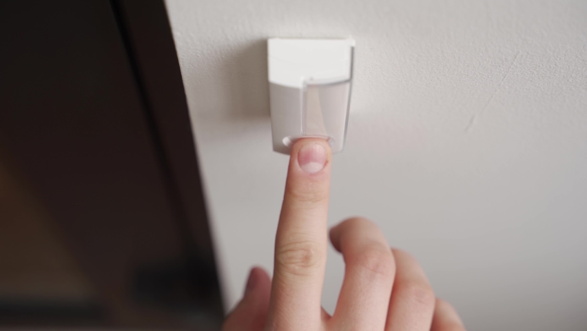 Person ringing doorbell with a finger. Man pushes door ring button a couple of times. Delivery courier ringing at the door. | Shutterstock HD Video #1083734500