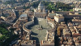 Aerial drone video of Saint Peter's world's largest church -Basilica of St. Peter's, Vatican and iconic Capella Sistine, Rome, Italy