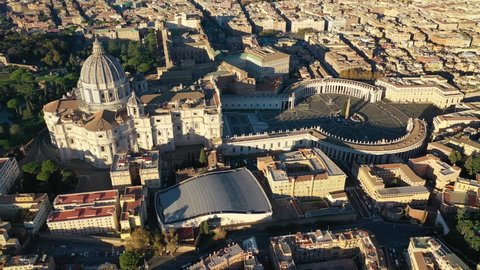 Aerial drone video of Saint Peter's square in front of world's largest church - Papal Basilica of St. Peter's, Vatican - an elliptical esplanade created in the mid seventeenth century, Rome, Italy
