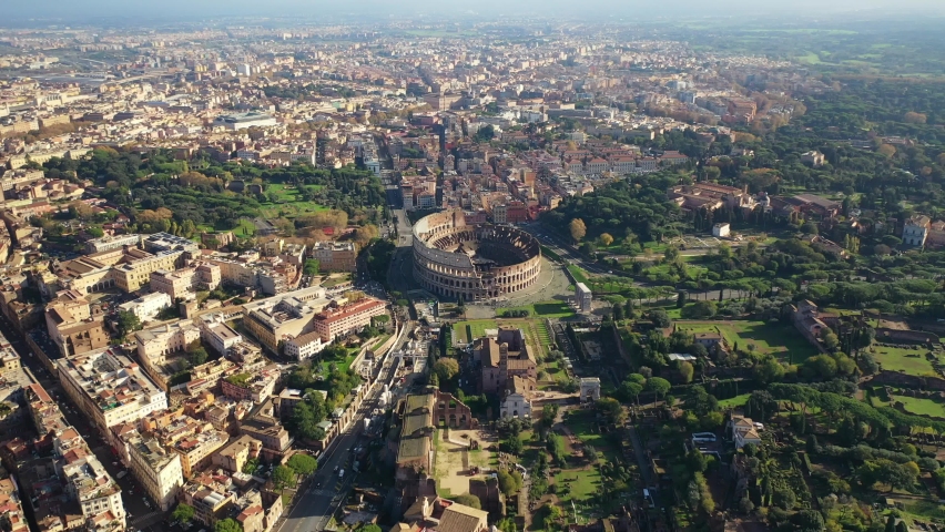 Aerial drone video of iconic park of Colosseum, a vast archaeological zone encompassing ancient sites like the Colosseum, Palatine hill and Ancient Forum, Rome historic centre, Italy Royalty-Free Stock Footage #1083735961