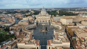 Aerial drone pull back video of Saint Peter's square in front of world's largest church - Papal Basilica of St. Peter's, Vatican - an elliptical esplanade, Rome, Italy