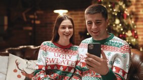 Family congratulates friends Merry Christmas on video communication. Couple sharing good news with friends and family on video chat during self isolation. Virtual celebration with friends video call