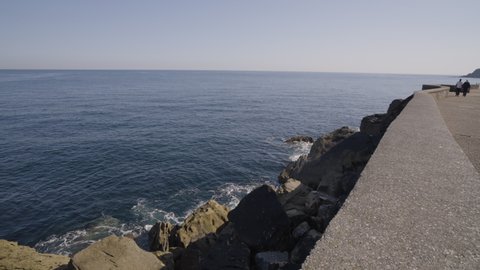 Coastal pathway and majestic rocky sea cliffside in San Sebastian