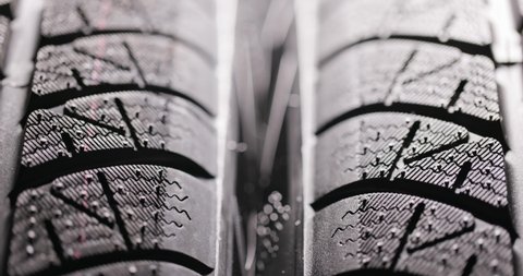 Clean car tyres spinning against dark background