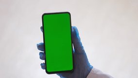 Handheld Camera: Point of View of Woman at Room Sitting on a Chair Using Phone With Green Mock-up Screen Chroma Key Surfing Internet Watching Content Videos Blogs Tapping on Center Screen
