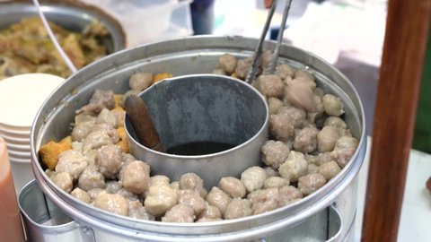 Pentol is a type of snack which can be found in Indonesia. it's a type of beef meatballs with flour, usually given with peanut sauce and sambal. 

Bakso or baso is an meatball from indonesia.
