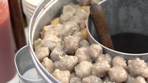 Pentol is a type of snack which can be found in Indonesia. it's a type of beef meatballs with flour, usually given with peanut sauce and sambal. 

Bakso or baso is an meatball from indonesia.