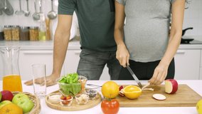 Pregnant Woman Preparing Healthy Breakfast While Husband Walking in Kitchen - Powered by Shutterstock - Get 15% off with code: PIKWIZARD15