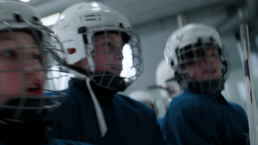 Kids cheering their teammate girl after scoring a goal during ice hockey game. Shot with 2x anamorphic lens Royalty-Free Stock Footage #1083766981